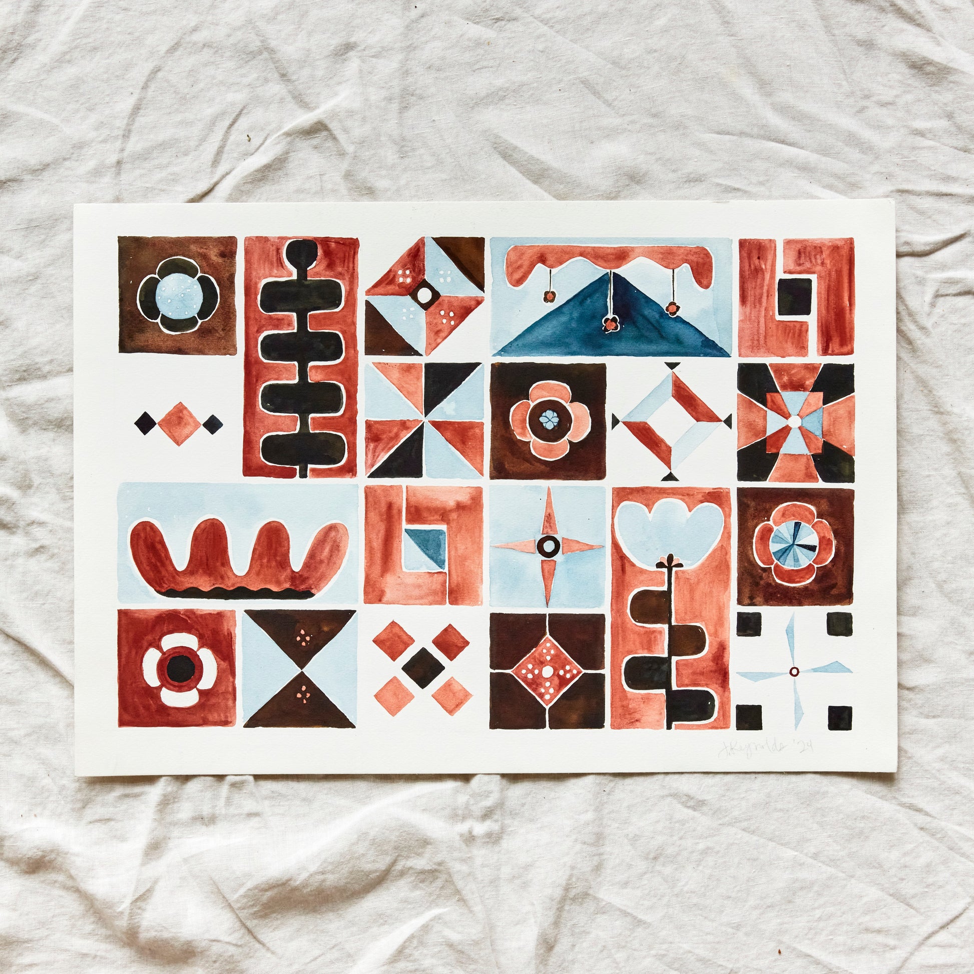 Austin watercolor artist Jaime Reynolds holds her folk patchwork terra cotta chestnut blue original painting